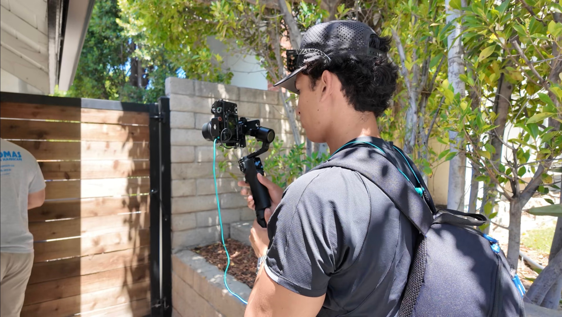 Filming a Thomas Pools crew member on a gimbal in a backyard